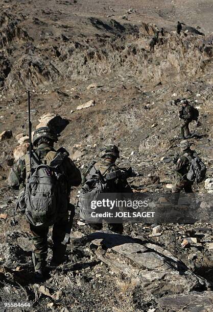 French soldiers from the OMLT of the Kandak 32 walk down a hill from an "Eagle's Nest" observation post in the Alah Say valley in Kapisa province on...