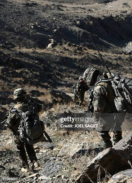 French soldiers from the OMLT of the Kandak 32 walk down a hill from an "Eagle's Nest" observation post in the Alah Say valley in Kapisa province on...