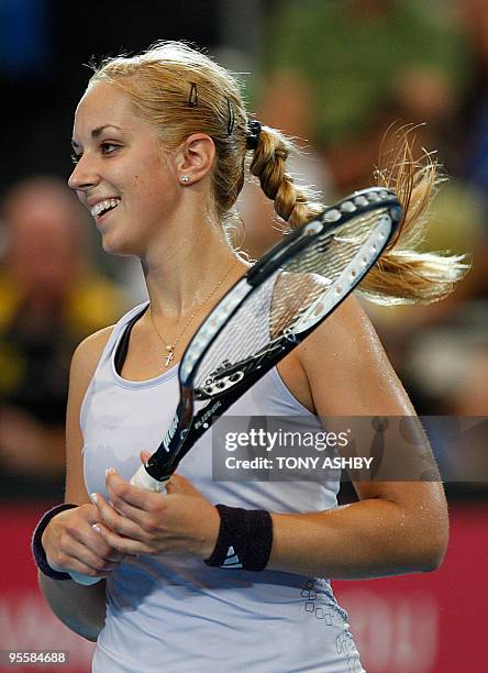 Sabine Lisicki of Germany smiles after scoring a winning point against Elena Dementieva of Russia in their women's singles match on the third session...