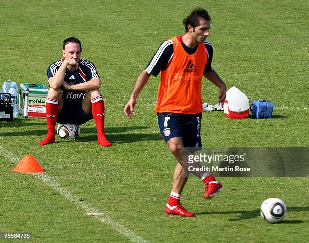 Franck Ribery of Bayern Muenchen watches his team mate Halil Altintop during the FC Bayern Muenchen training session at the Al Nasr training ground...