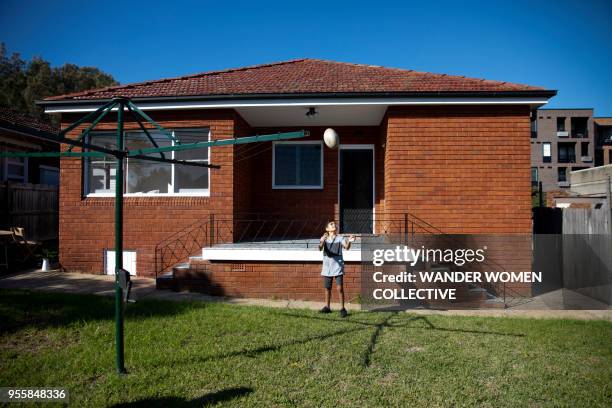 indigenous australian aboriginal boy playing with rugby ball in backyard - rugby league 個照片及圖片檔