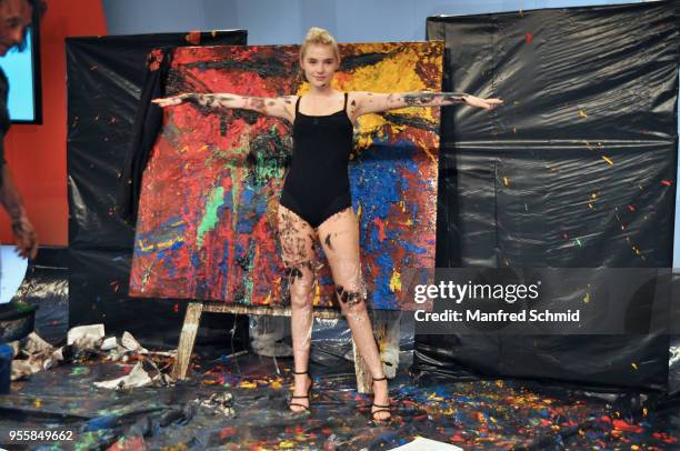 Model poses in front of a picture painted by Guenter Edlinger during the Pro Juventute Charity Fashion Show on May 7, 2018 in Vienna, Austria.