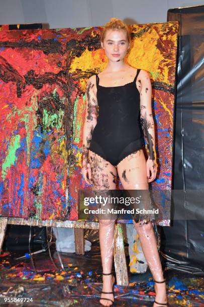 Model poses in front of a picture painted by Guenter Edlinger during the Pro Juventute Charity Fashion Show on May 7, 2018 in Vienna, Austria.