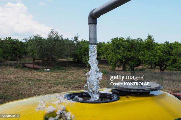 Preparation of the pesticides anti-parasitic mixture on a farm. The use of pesticides is being reduced all over the world as they pollute groundwater...