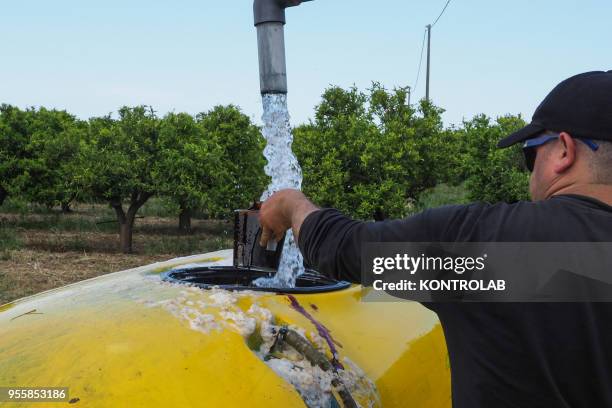 Worker prepares the pesticides anti-parasitic mixture on a farm. The use of pesticides is being reduced all over the world as they pollute...