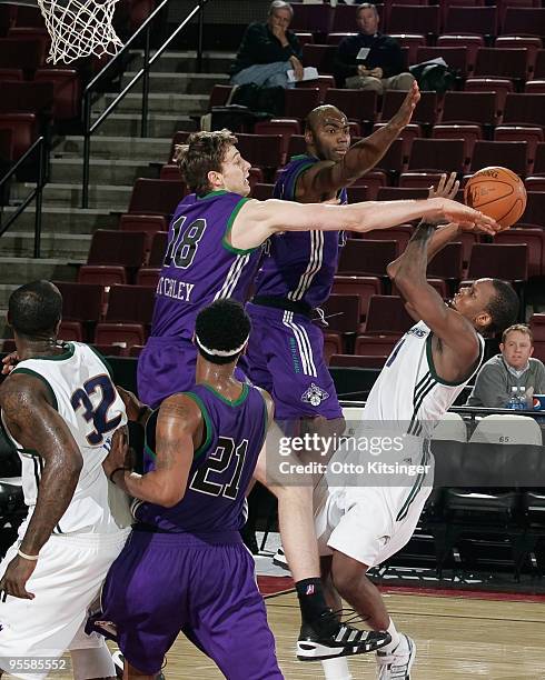 Connor Atchley of the Dakota Wizards tries to block a shot by Russell Robinson of the Reno Bighorns during the 2010 D-League Showcase at Qwest Arena...