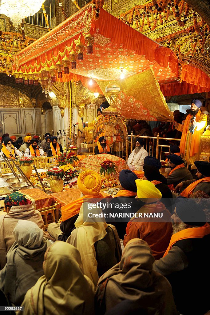Indian Sikh priest Jagtar Singh sits beh