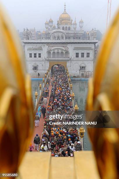 Indian Sikh devotees wait to pay their respects inside The Golden Temple in Amritsar on January 5, 2010. The ceremony was held to mark the 344th...