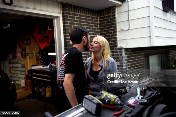 Sarah Janeczko 20, sneaks in for a kiss from her boyfriend Anthony "Panda" Howard-Martinez 22, as he adding his signature airhorn on the new, old...