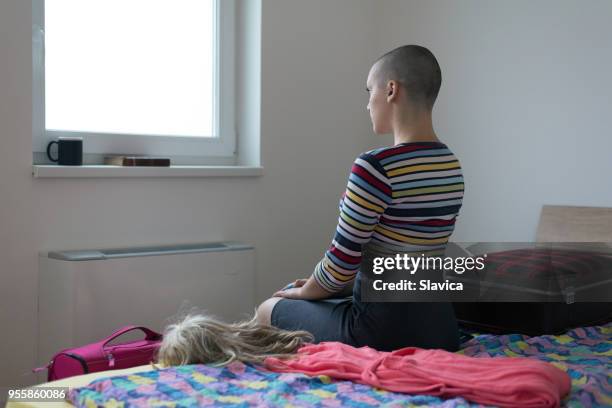 female cancer patient leaving hospital - fighting cancer stock pictures, royalty-free photos & images