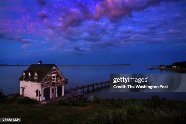 Boarded up home with pier on the Chesapeake Bay on Hooper's Island, Maryland provided the perfect foreground for a colorful dusk sky. Hoopersville is...