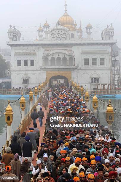 Indian Sikh devotees wait to pay their respects inside The Golden Temple in Amritsar on January 5, 2010. The ceremony was held to mark the 344th...