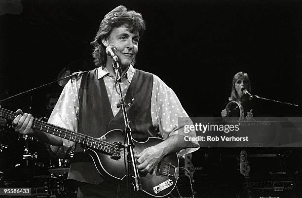 Paul McCartney, and wife Linda McCartney behind, perform on stage at the Playhouse Theatre during a press showcase on July 27th 1989 in London. Paul...