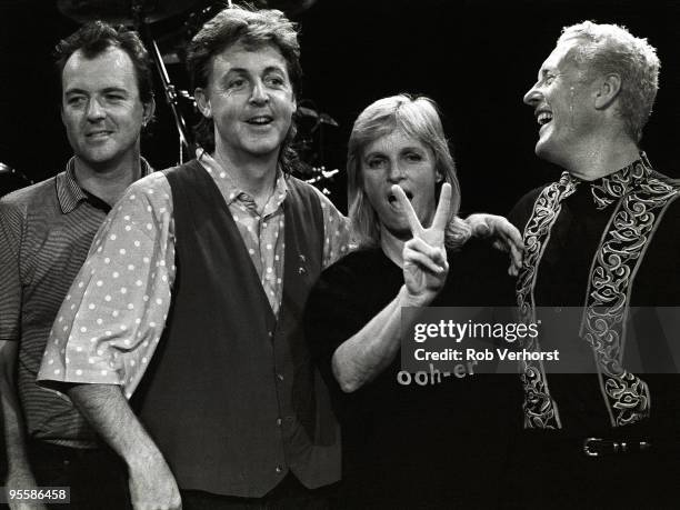Paul McCartney and band pose on stage at the Playhouse Theatre, with Robbie McIntosh, Paul McCartney, Linda McCartney and Hamish Stuart, during a...