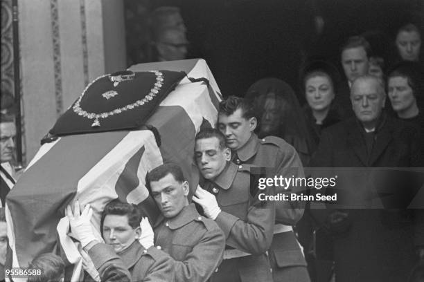 England, London, St.Paul's Cathedral, guardsmen carry the draped coffin of Sir WInston Churchill down the steep steps of the cathedral. In the...