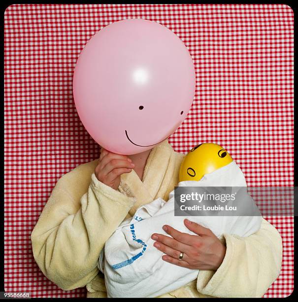 female with balloon as face holding baby balloon - funny baby face stock pictures, royalty-free photos & images
