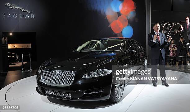 Managing Director Jaguar Mike O'Driscoll poses with the newly unveiled Jaguar XJ car during the 10th Auto Expo in New Delhi on January 5, 2010....