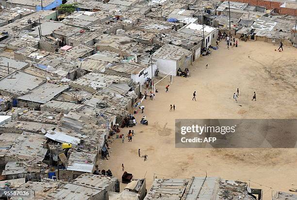 Residents walk in the shanty town of Boa Vista in Luanda on December 21, 2009. The OPEC oil producers' cartel will hold output quotas unchanged at...