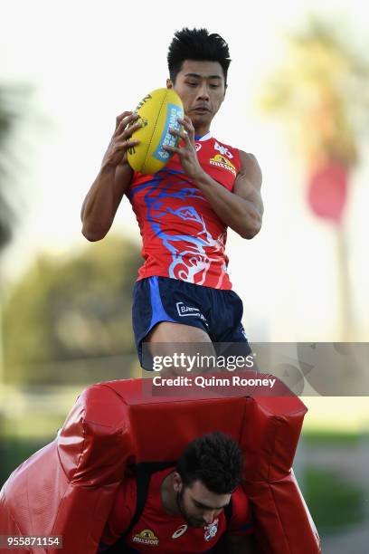 Lin Jong of the Bulldogs marks during a Western Bulldogs AFL training session at Whitten Oval on May 8, 2018 in Melbourne, Australia.