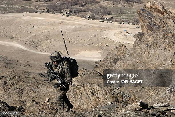 French soldiers of the Operational Mentoring and Liaison Teams of the Kandak 32 climb to the observation post, 'the eagle nest' in the Alah Say...