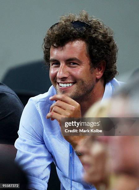 Australian golfer Adam Scott watches his girlfriend Ana Ivanovic of Serbia during her second round match against Timea Bacsinszky of Switzerland...