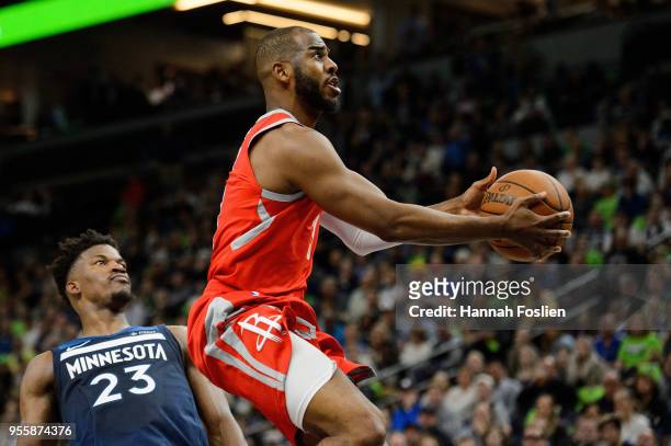 Chris Paul of the Houston Rockets shoots the ball against Jimmy Butler of the Minnesota Timberwolves in Game Four of Round One of the 2018 NBA...