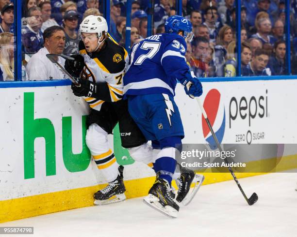 Yanni Gourde of the Tampa Bay Lightning against Charlie McAvoy of the Boston Bruins during Game Five of the Eastern Conference Second Round during...