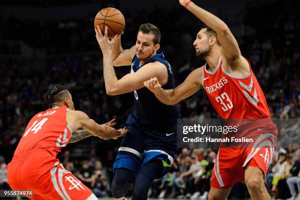 Nemanja Bjelica of the Minnesota Timberwolves drives to the basket against Gerald Green and Ryan Anderson of the Houston Rockets in Game Four of...