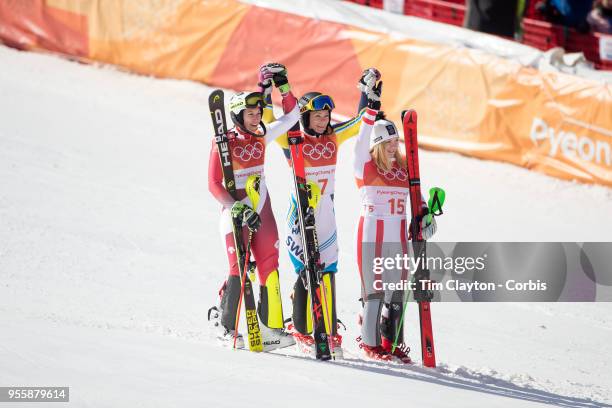 Frida Hansdotter of Sweden celebrates after winning the gold medal with silver medal winner Wendy Holdener of Switzerland and bronze medal winner...