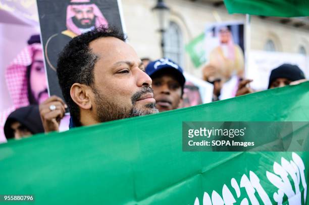 Pro-Saudi demonstrator stands behind a Saudi Arabian flag on Whitehall in celebration of the visit of Crown Prince Muhammad bin Salman, heir to the...