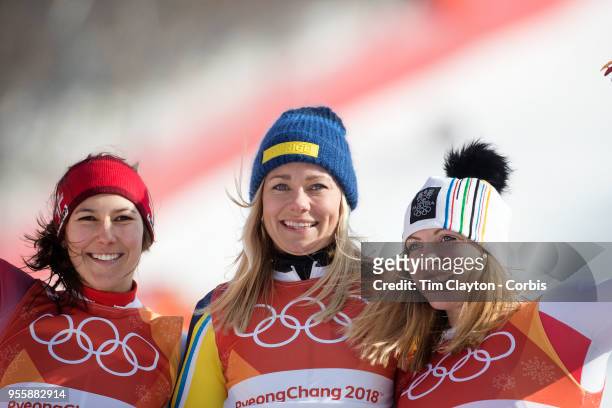 Frida Hansdotter of Sweden celebrates on the podium after winning the gold medal with silver medal winner Wendy Holdener of Switzerland and bronze...