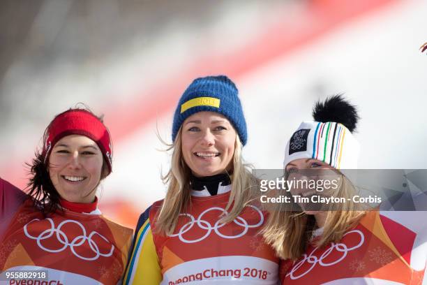 Frida Hansdotter of Sweden celebrates on the podium after winning the gold medal with silver medal winner Wendy Holdener of Switzerland and bronze...