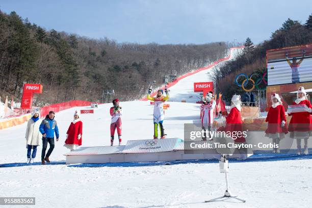 Frida Hansdotter of Sweden celebrates on the podium after winning the gold medal with silver medal winner Wendy Holdener of Switzerland and bronze...