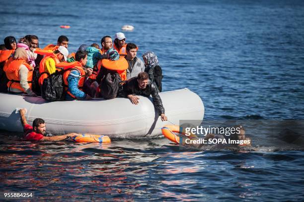Salam Aldeen , a Danish founder of Team Humanity, and another volunteer guide a boat full of migrants whose engine has stalled and were arriving on...