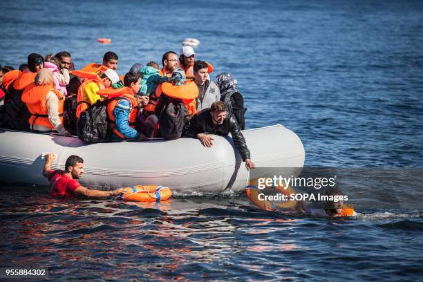 Salam Aldeen , a Danish founder of Team Humanity, and another volunteer guide a boat full of migrants whose engine has stalled and were arriving on...