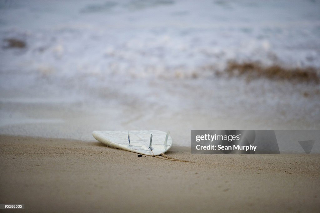 Surfboard washed up on beach