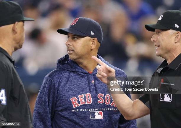 Manager Alex Cora of the Boston Red Sox meets at home plate with the umpiring crew including home plate umpire Dan Iassogna before the start of MLB...