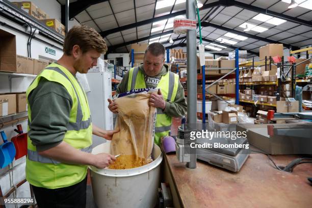 Employees pack fishing bait at the C.C. Moore and Co. Ltd. Fishing bait manufacturing plant in Stalbridge, U.K., on Monday, April 23, 2018. All...
