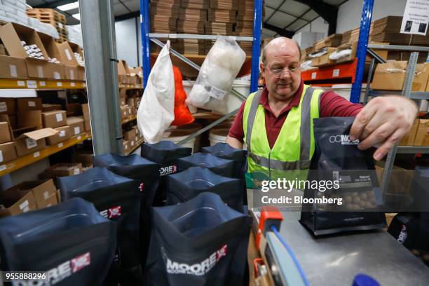 An employee packs fishing bait at the C.C. Moore and Co. Ltd. Fishing bait manufacturing plant in Stalbridge, U.K., on Monday, April 23, 2018. All...