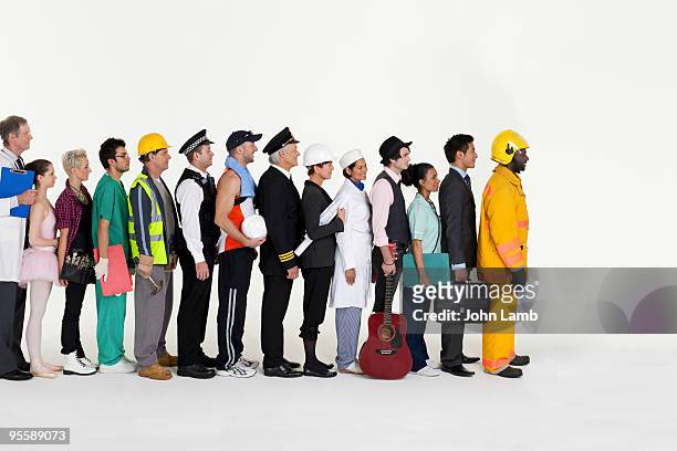 workers in line - uniform werk stockfoto's en -beelden