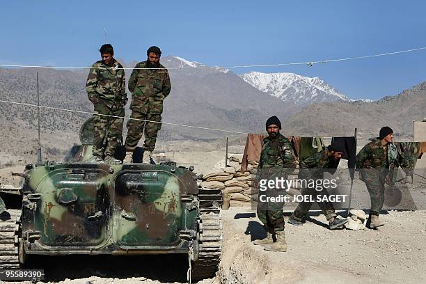 Afghan soldiers of the Operational Mentoring and Liaison Teams of the Kandak 32 mill about at the Combat Out Position Belda, named in memory of...