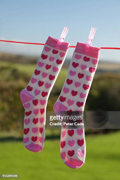 heart socks hanging on line - pair stock photos et images de collection