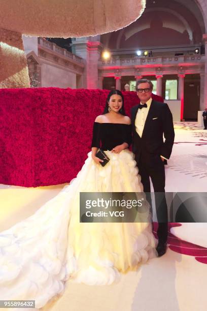 Investor and philanthropist Wendy Yu poses with actor Colin Firth as she leaves the hotel to attend the Heavenly Bodies: Fashion & The Catholic...