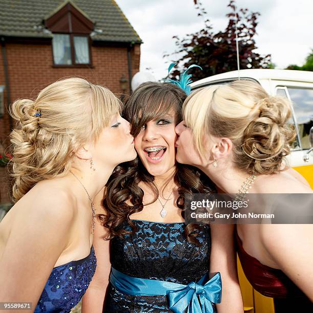 youngs girls kiss friends cheek  - newfamily stock pictures, royalty-free photos & images