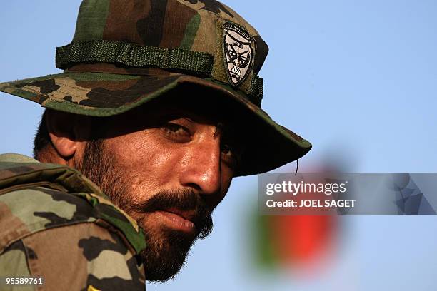 An Afghan National Army soldier from the OMLT of the Kandak 32 is seen on sentry duty at a combat outpost in the Alah Say valley in Kapisa province...