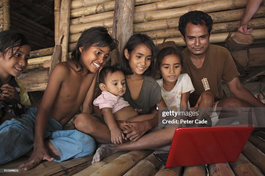 Family from indonesia looking at laptop