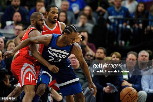 Chris Paul and Trevor Ariza of the Houston Rockets defend against Andrew Wiggins of the Minnesota Timberwolves in Game Three of Round One of the 2018...