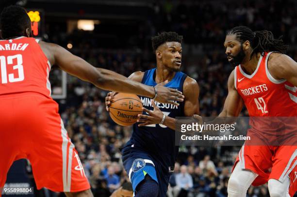 Jimmy Butler of the Minnesota Timberwolves drives to the basket against James Harden and Nene Hilario of the Houston Rockets in Game Three of Round...