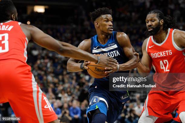 Jimmy Butler of the Minnesota Timberwolves drives to the basket against James Harden and Nene Hilario of the Houston Rockets in Game Three of Round...