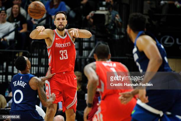 Ryan Anderson of the Houston Rockets passes the ball to teammate Trevor Ariza and away from Jeff Teague of the Minnesota Timberwolves in Game Three...